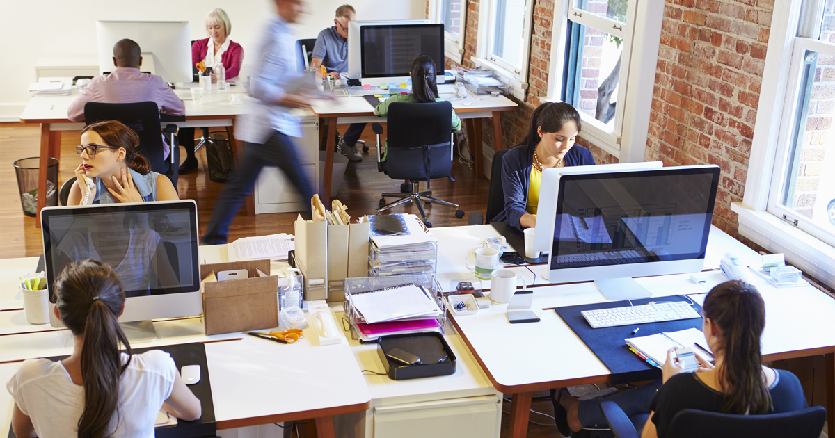 Wide Angle View Of Busy Design Office With Workers At Desks