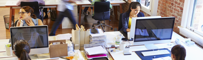 Wide Angle View Of Busy Design Office With Workers At Desks