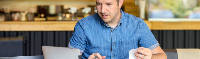 Mature small business owner calculating finance bills of activity