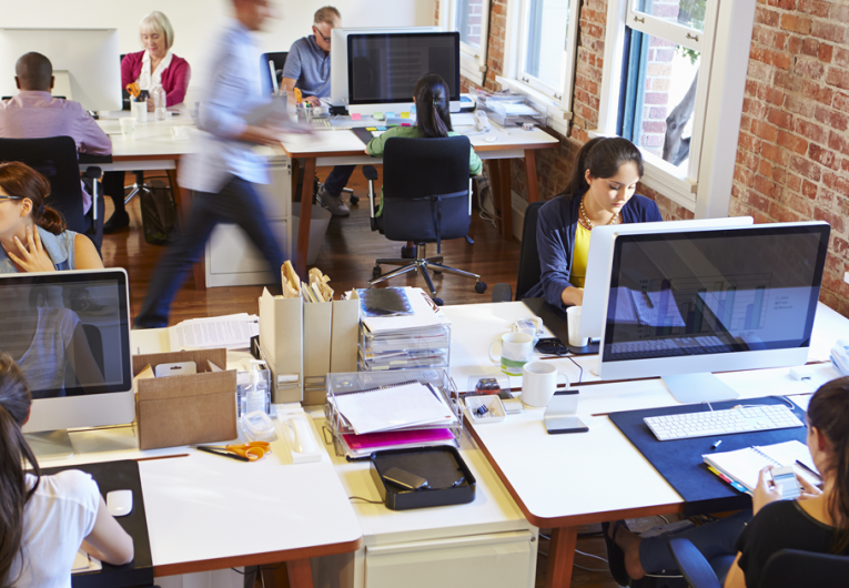 Wide Angle View Of Busy Design Office With Workers At Desks