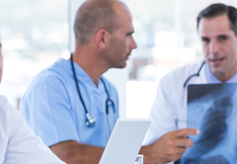 Healthcare workers reviewing patient x-rays