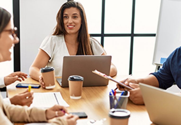 A group of business professionals brainstorming marketing ideas at a conference table.