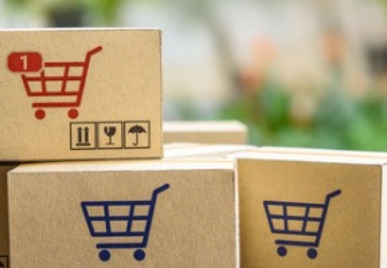 Online shopping carts boxes in front of laptop